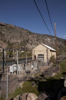 a power plant next to the river in the middle of the forest powerstation building old