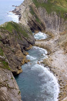 A view looking over the cliff face at Lulworth Cove in Dorset UK.