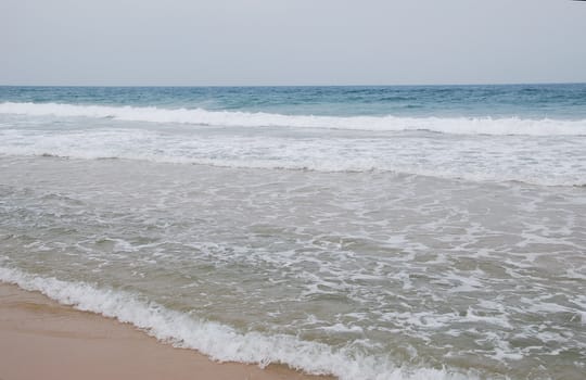 Waves running on sandy coast of Mediterranean sea