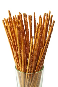 Saltsticks in a glass on white background