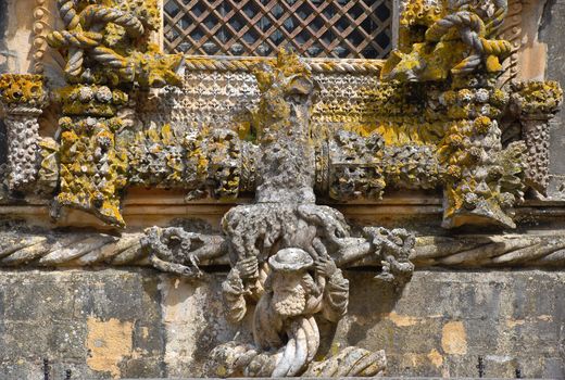 Detail with author face of the most famous window in manuelino-style, Christ Convent cloister, Tomar, Portugal. 