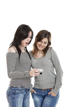 Two beautiful young woman watching pictures on a Camera