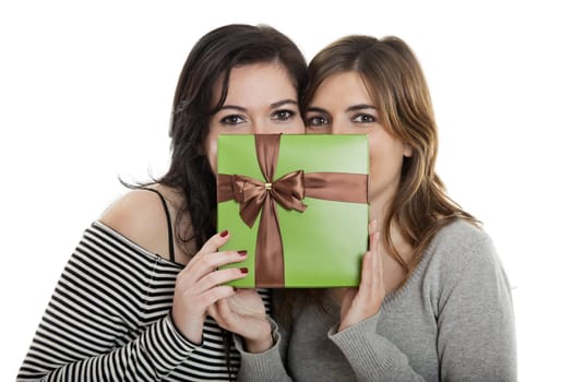 Two beautiful young women�s holding a present
