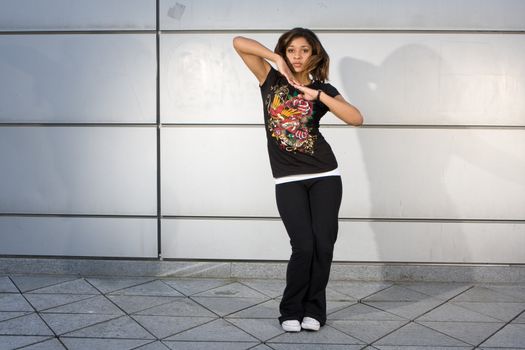 Young teenager grooving to hip hop music on the dance floor