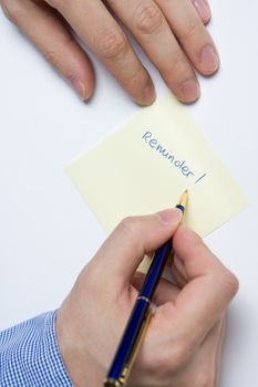 Person writing a message on a piece of paper or note