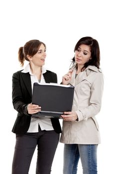 Two female young students watching something on a laptop