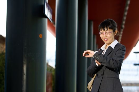 Asian business woman traveller on a trip at the train station