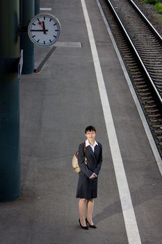 Asian business woman traveller on a trip at the train station