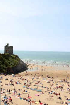 ballybunion beach crowded with people on a hot day with castle