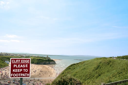 a warning sign on a cliff path walk