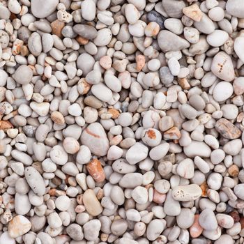 Naturally rounded gravel at sea shore. Nature background texture pattern.