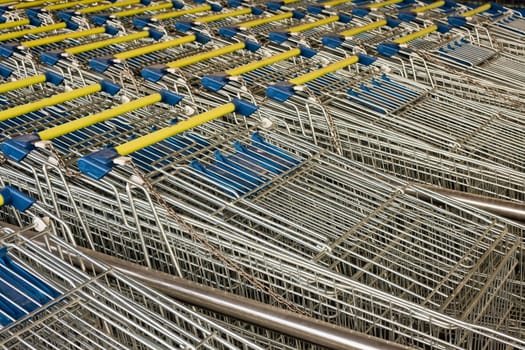 Rows of ready to use shopping carts lined-up in rows for storage.