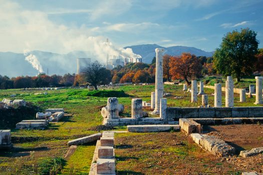 Antique ruins of Tersilion theatre and modern coal power plant at Megalopolis, Peloponnes, Greece, Europe.