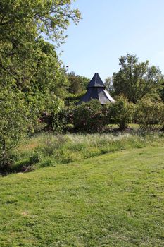 Close up of a white gazebo in a garden.