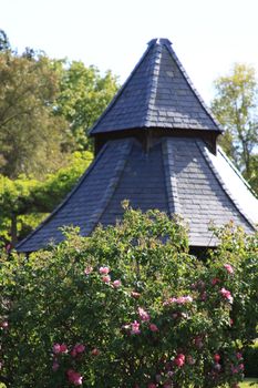 Close up of a white gazebo in a garden.