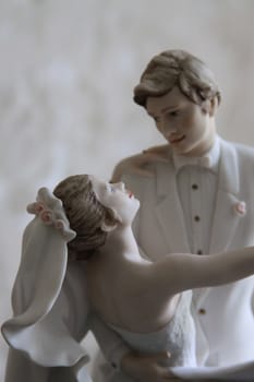 Wedding Figurines close up over background.