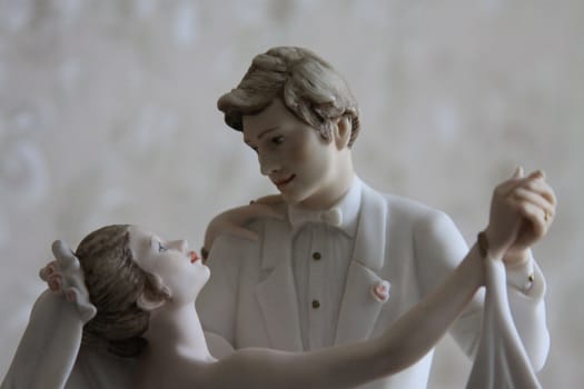 Wedding Figurines close up over background.