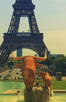 Bull and calf statue at the Trocadero, Paris France looking towards the Tour Eiffel. A retro effect applied evocative of the 1960's period.