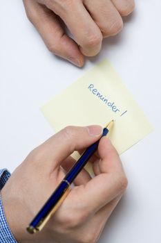 Person writing a message on a piece of paper or note