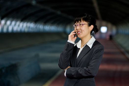 Asian business woman posing with mobile or hand phone, modern communication