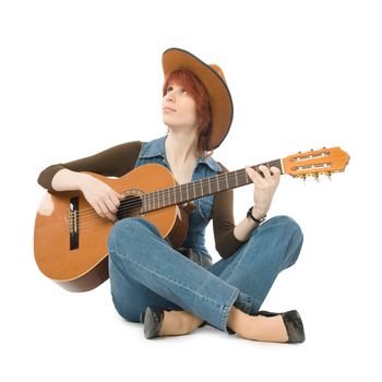 Woman sitting on a floor and playing guitar