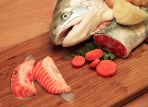 Fresh red salmon fish on wooden cooking desk
