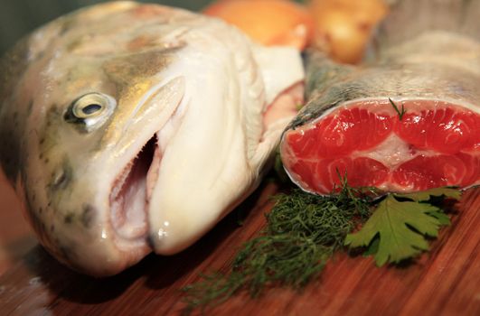Fresh red salmon fish on wooden cooking desk