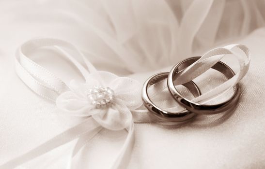 Wedding rings on a satiny fabric