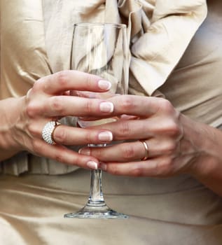 Glass of champagne in a hand of the bride