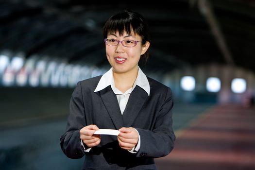 Asian woman giving her business calling card with a friendly smile