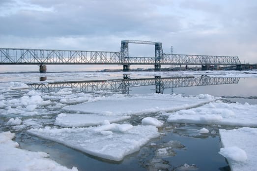 Railway bridge by springtime.Driving of ice goes On river
