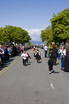 A street in Trondheim on Norway's Constitution Day. Spectators are lined up for the next parade while the kids play around in their national dresses - the bunad. 
