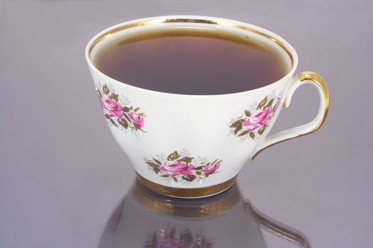 full white china cup of tea with reflection