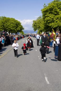 A street in Trondheim on Norway's Constitution Day. Spectators are lined up for the next parade while the kids play around in their national dresses - the bunad. 