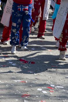 The parade is popular amongst the Russ - students in their last year of upper secondary school that celebrate the end of 13 years of school. This is their costumes during celebration, and their business cards and party effects lay on the streets. 