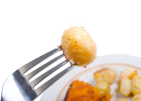 baked potatoes,roasted vegetables Close-up .fork with potatoes