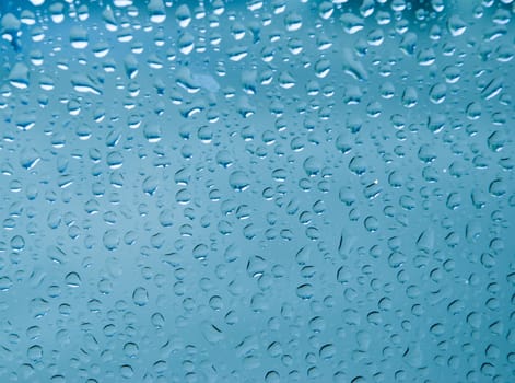 Waterdrop on glass Close-up.blue background