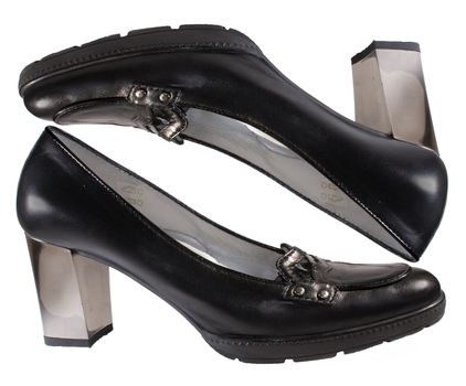 Pair of black woman's shoes with high mirror heel as if they were packed in a box