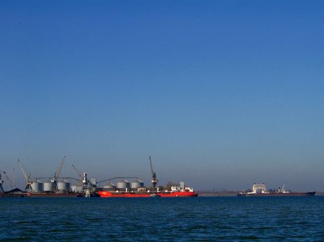 Red oil tanker on seaport