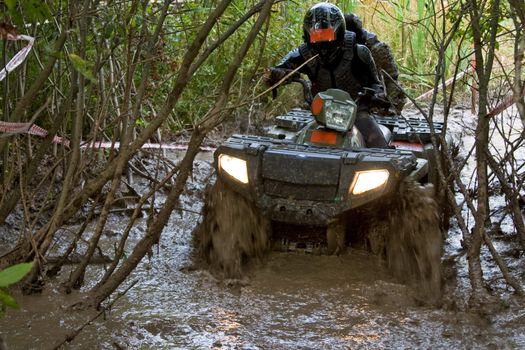 Sportsman riding quad bike at extreme competition