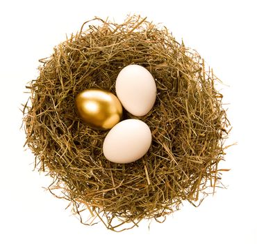 Two simple and one gold eggs lay in a nest
