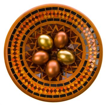 Beautiful Easter eggs lay on a celebratory dish
