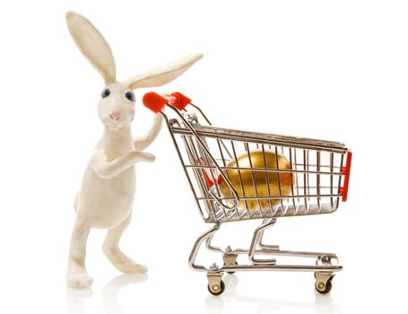 Easter rabbit carries the cart with gold egg
