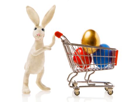 Easter rabbit carries the cart with multi-coloured eggs
