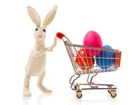 Easter rabbit carries the cart with multi-coloured eggs
