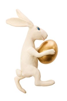  White toy rabbit with gold egg.The image contains a path
