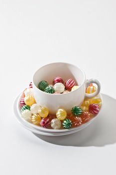 different colors of stripy lollipops on the white cup