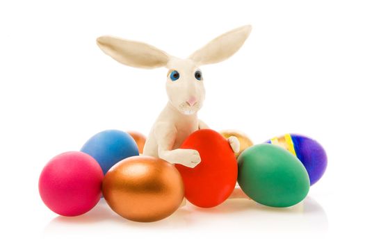  Rabbit sits near to  Easter eggs.The image contains a path.