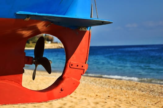 Boat screw with beach and sea in the background