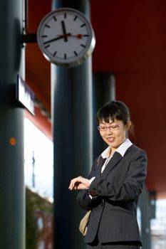 Asian business woman traveller on a trip at the train station